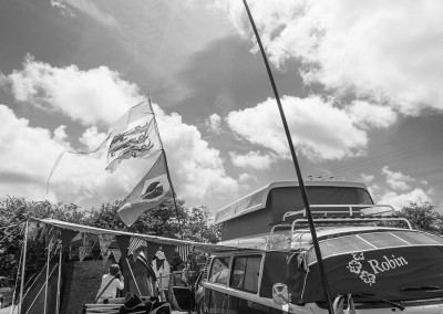 Camper van with flags in the camping field at Priddy Folk Festival