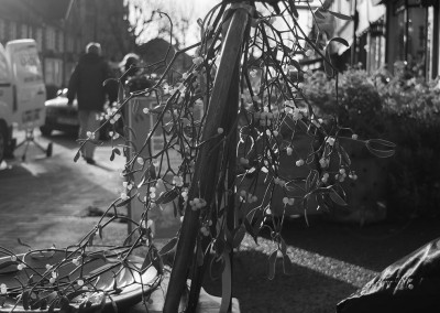 Mistleotoe on the back of a chair in the street outside a shop