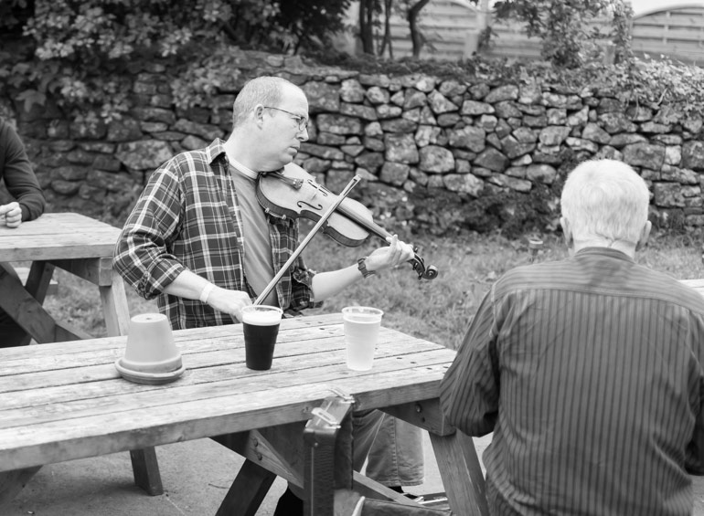 A pub session starts outside the pub in Priddy durring the festival